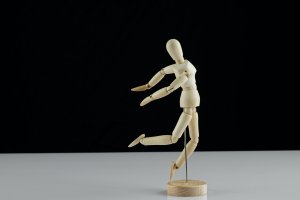 wooden human model poses on the table
