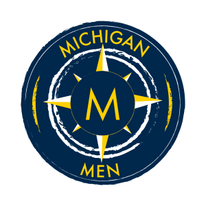 Michigan Men Logo: Yellow M within a yellow compass on navy background