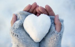 hands holding snow heart