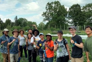 Students holding carrots at the U-M Campus Farm.