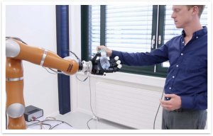 Robot hands over a water bottle