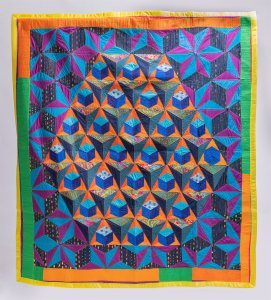 a patchwork quilt featuring a geometric pattern in bright colors - orange, green, cyan, and magenta