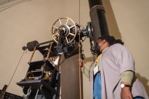 Woman looking through telescope.