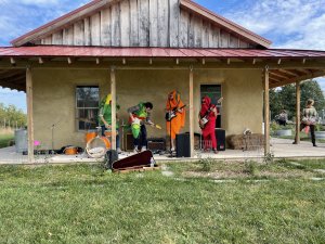 Band wearing vegetable costumes playing music at the Campus Farm