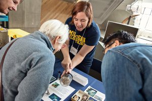 Scientist demonstrating research to group of people