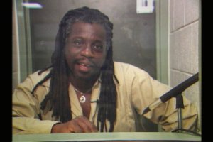 Still from Dope is Death, showing an interview with Mutulu Shakur