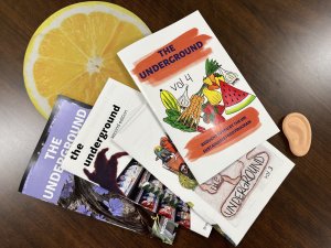 The cover of four issues of The Underground zine, featuring colorful collaged covers with fruits, vegetables, and photos of students