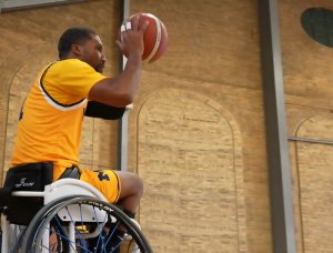 A photo of a wheelchair basketball player getting ready to shoot a basket