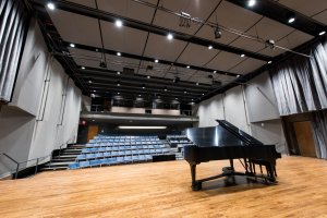 Piano on stage in an empty auditorium in the SMTD Moore Building
