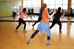 Group of people dancing in a workout class.