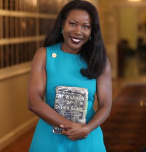 Author Isabel Wilkerson holding a copy of "The Warmth of Other Suns."