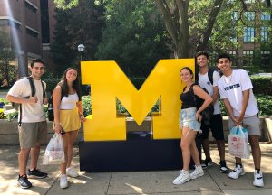 Students pose for a photo with the Block M.