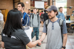 Student shaking hands with a company representative