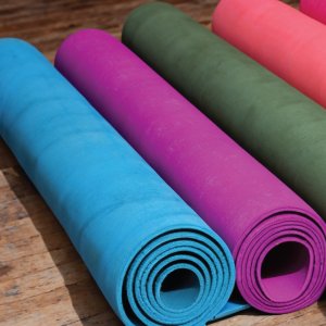 Yoga mats on a rustic wooden floor.