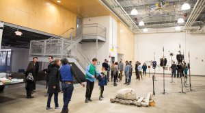 People view an exhibition of MFA work at the faculty and graduate studios.