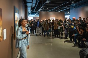 A student gives a talk on her work at the 2023 Undergraduate Juried Exhibition