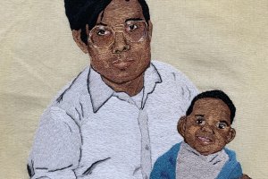 Photograph of hand-embroidered portrait by Fatema Haque of a Bangladeshi American father and his child. Courtesy of Fatema Haque.