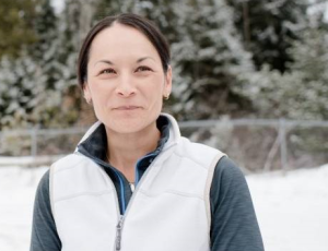 Woman standing in snow field