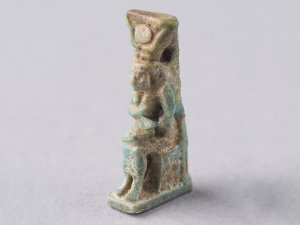 Faience amulet of Isis/Horus wearing a crown of cow’s horns and a solar disk.