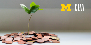 Small plant growing out of a pile of change