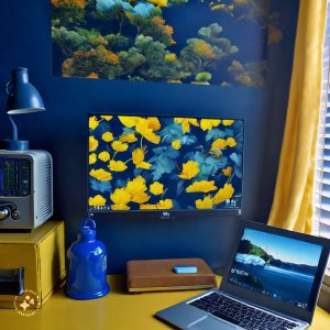navy blue and yellow dorm room that has a desk with a laptop showcasing a tranquil screensaver
