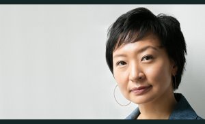 Headshot of Cathy Park Hong from the neck up wearing large hoop earrings