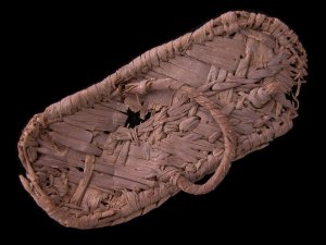 Broken sandal made of woven palm.