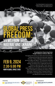 The picture shows several reporters' microphones framed by barbed wire