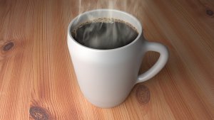 Steaming cup of coffee in a white mug.