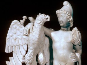 White marble statuette of Ganymede, a young man wearing a Phrygian cap, with his arm around an eagle.