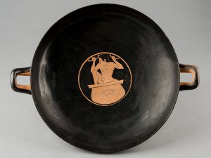 Two-handled Greek red-figure kylix with a representation of a youth treading grapes.