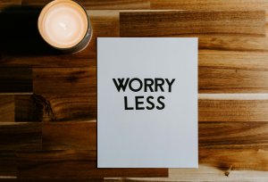 Worry less message on paper with cutout letters