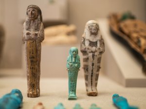 View of Kelsey Museum display showing three upright ushabtis.