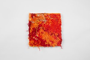 Orange and red textile artwork by Ericka Lopez