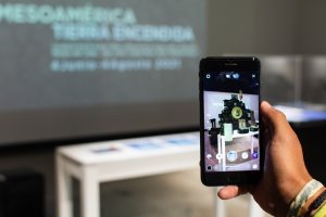 A phone's camera displays an image of a projection on a screen.