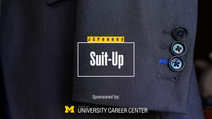 Close-up of a dark suit sleeve with buttons and text reading "JCPenney Suit-Up Sponsored by: UNIVERSITY CAREER CENTER"