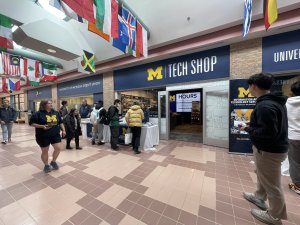 Passersby check out the ITS informational table outside the Tech Shop on north campus.