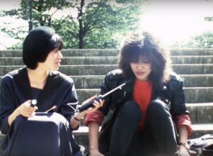 Kirsten Seuffert and another individual sitting on steps and talking