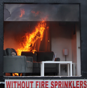 Photo of a living room on fire in a fire demonstration trailer.