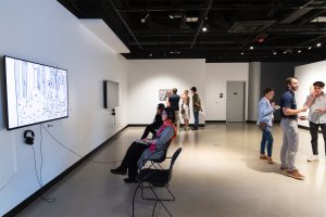 Visitors view work at the 2024 Commence exhibition.