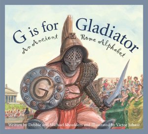 The cover of the children’s book “G Is for Gladiator: An Ancient Rome Alphabet,” by Debbie and Michael Shoulders, featuring an armored fighter holding a shield and sword and a crowd in the stands of the Colosseum.