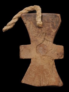 Carved wooden cross pendant with a string of rope attached.
