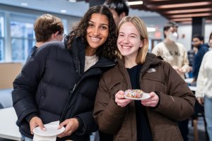 Students holding donuts