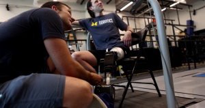 Kevin Best attends to the open source leg on a person who uses a prosthetic leg. Kevin Best attends to the open source leg on a person who uses a prosthetic leg.