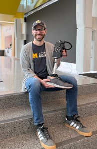 Ross Cortino holds up a robotic prosthetic leg. Ross Cortino holds up a robotic prosthetic leg.