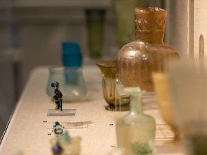 Kelsey Museum display case housing an array of glass vessels of different shapes, sizes, and colors.