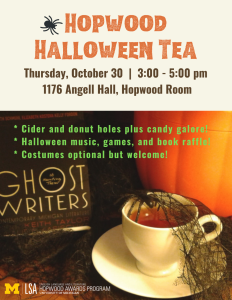 Spider-webbed teacup in front of a pumpkin and scary book.