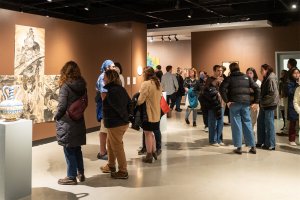 Gallery visitors look at work at an exhibition