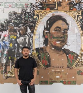 Narsiso Martinez stands in front of his work