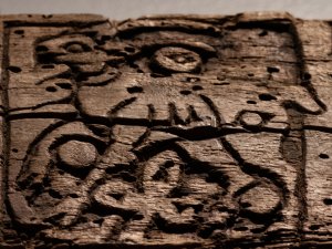 Close-up of a carved wooden relief panel picturing a hare.